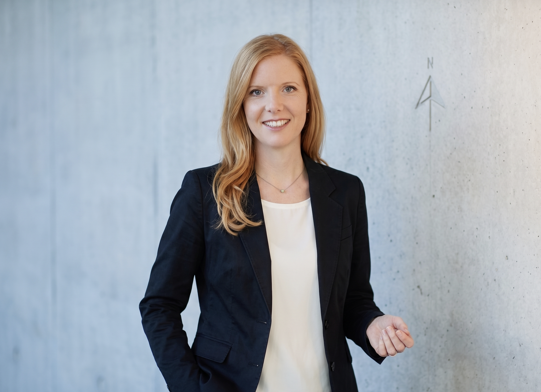 portrait anja geiger graue wand mit kompass